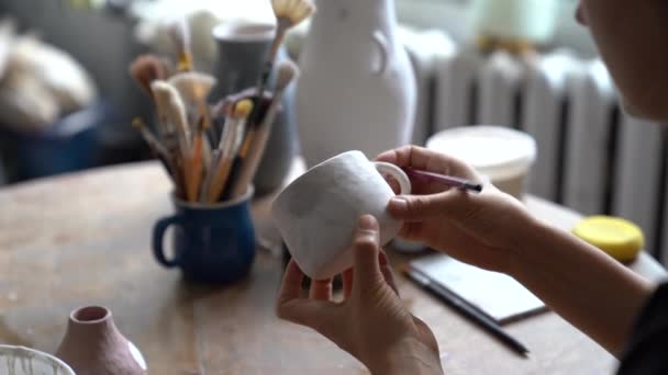 Young Craftswoman Prepares Painting Mug Pencil Sitting Wooden Table Workshop — Stockvideo