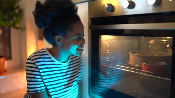 Handsome African American Housewife Striped Shirt Sits Modern Oven Kitchen — Vídeo de Stock