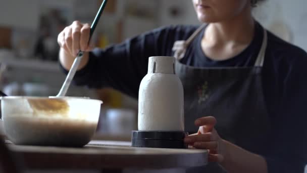 Woman Black Apron Paints Ceramic Vase White Color Brush Sitting — Stockvideo