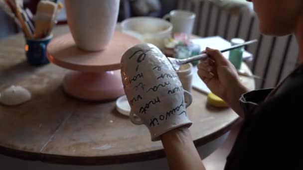 Young Craftswoman Paints Handmade Vase Using Professional Equipment Sitting Table — Stockvideo