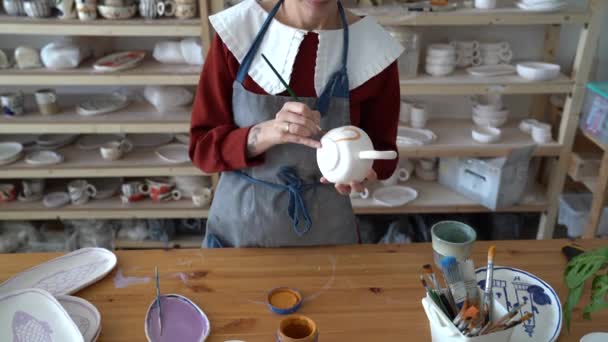 Young Woman Potter Wearing Apron Decorating Pottery Baking While Working — Stock Video