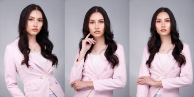 20 'li yaşların Asyalı güzel, bronzlaşmış vücut portresi siyah saçlı kadın pastel pembe resmi elbise giyiyor. Ofis Kadını ifadesiyle güler yüzlü mutlu iş yerinde kendine güvenen çoğu kişi gri arka planda poz verir.