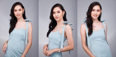 20 'li yaşların Asyalı güzel, bronzlaşmış vücut portresinin yarısı siyah kadın saçı pastel yeşil resmi elbise giyiyor. Ofis Kadını ifadesiyle güler yüzlü mutlu iş yerinde kendine güvenen çoğu kişi gri arka planda poz verir.