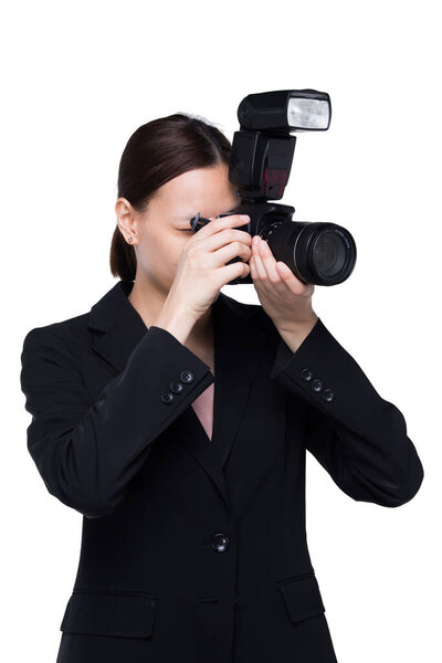 Asian Woman Photographer hold camera with external flash point to shoot subject, wear normal suit jacket. studio lighting white background isolated copy space, reporter journalist take photo celebrity