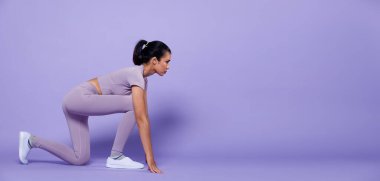 Tam boy Asyalı Slim Fitness Kadını ısınma egzersizi esnek bahar zıplama bacakları, stüdyo mor arka plan fotokopi alanı, konsept Kadın Çok Peri renk bloğu tonu ile atlet yapabilir