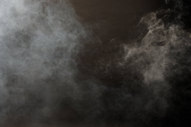 Siyah Arkaplanda Yoğun Tüy Tüten Duman ve Sis, Soyut Duman Bulutları, Odakta Bulanık Hareket. Kuru buz sineğinden duman üfleme ve havada kanat çırpma dokuyu etkiler.