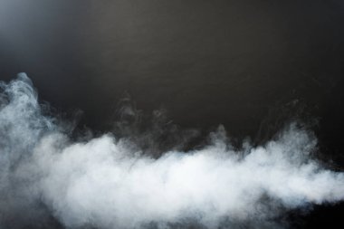 Dense Fluffy Puffs of White Smoke and Fog on Black Background, Abstract Smoke Clouds, Movement Blurred out of focus. Smoking blows from machine dry ice fly and fluttering in Air, effect texture clipart