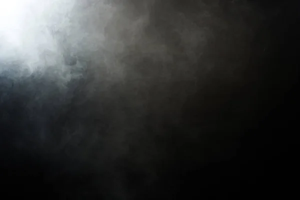 Dense Fluffy Puffs of White Smoke and Fog on Black Background, Abstract Smoke Clouds, Movement Blurred out of focus. Smoking blows from machine dry ice fly and fluttering in Air, effect texture