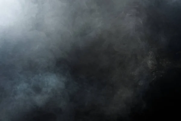 Dense Fluffy Puffs of White Smoke and Fog on Black Background, Abstract Smoke Clouds, Movement Blurred out of focus. Smoking blows from machine dry ice fly and fluttering in Air, effect texture