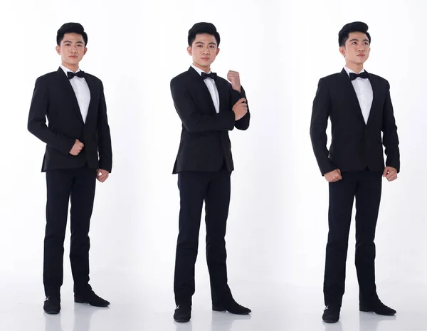 Full Length 20s Asian Business man wear black Formal Suit pants shoes for Gala Dinner and celebrate meeting. Young Smart Male stand confident feeling happy smile. White background isolated