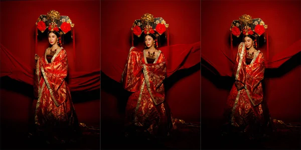 アジアの女性は中国を身に着けています黄金のラインデザインのドレスとヘッドウェアとロイヤル皇后伝統衣装 劇的なシリーズの女性は 空気中でなびく生地と完全な長さをスタンド トーン赤の背景 — ストック写真