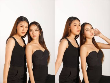 Two Best Friends Half Body Portrait of 20s Asian beautiful Women black long straight hair wear black dress. Females express feeling smile happy and hug close together over white Background isolated