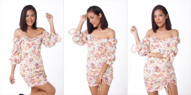 20 'li yaşlarda, Asyalı güzel bir kadının vücut portresi. Kısa siyah, bronz tenli. Çiçek desenli, güzel elbise giyiyor.