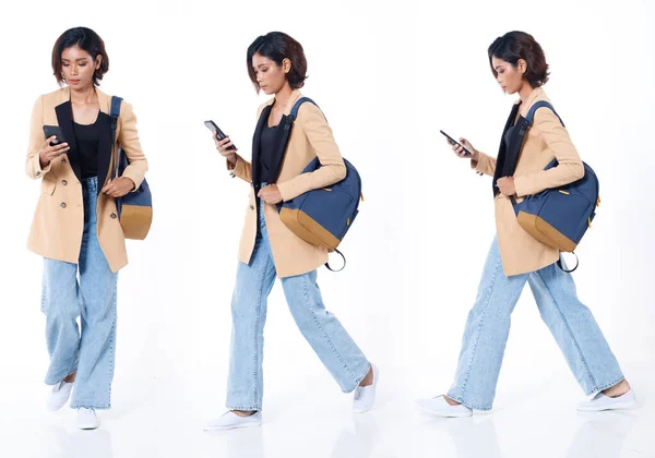 Collage Full length of Asian Indian 20s working woman with curl hair hold cell smart phone, backpack, blazzer and jean pants. Female walk forward side and work internet over white background isolated