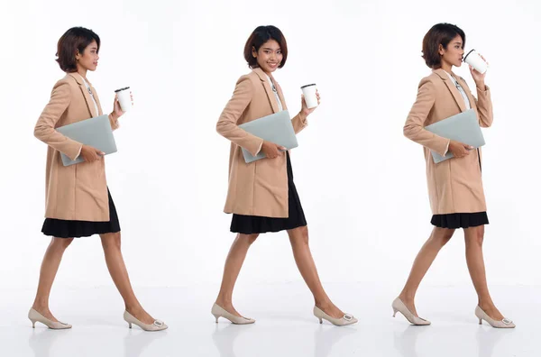 대젊은 아시아 비지니스 사업가가 스커트를 왼쪽으로 갑니다 사무실 여자가 노트북 — 스톡 사진