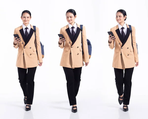 Full length 20s young Mix Race Woman business salesman backpacks, walking forward left right, wear formal blazer and shoes. Office female stands feels happy smile over white background isolated