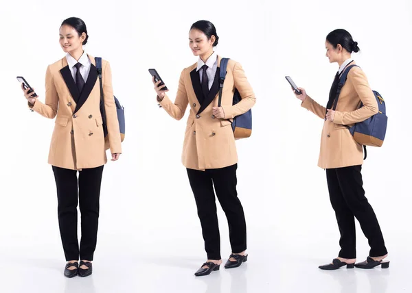 Full length 20s young Mix Race Woman business salesman backpacks, working looking internet phone, wear formal blazer and shoes. Office female stands feels happy smile over white background isolated