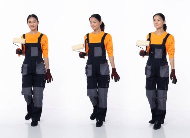 20 'li yaşlarda, genç Asyalı kadın dekorasyon ressamı, sol öne doğru yürüyor, turuncu tulum üniformalı eldivenler giyiyor. Gülümse, mutlu kadın. Beyaz arka planda boya fırçası tut.