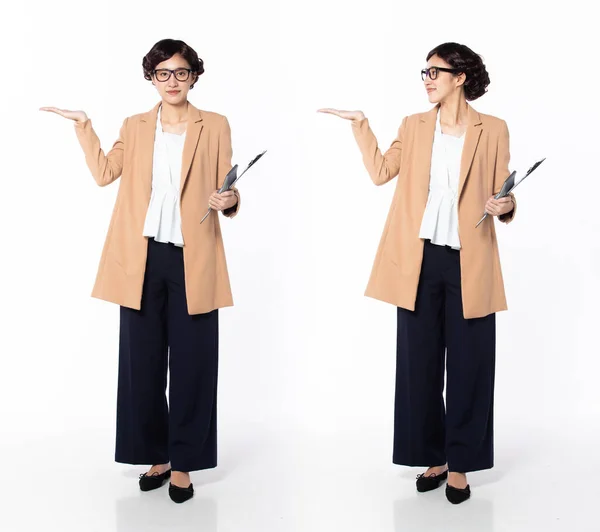 Full length 30s 40s Asian Woman Tax Financial Accountant, showing empty palm hand, wear formal blazer pants shoes. Smile Office female carry calculator folder over white background isolated