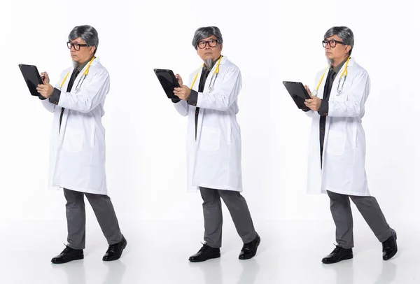 Full length 50s 60s Asian Chinese Hospital Doctor Medical man, walking forward left right, wear formal working suit. Silver gray Hair male hold tablet patient chart over white background isolated