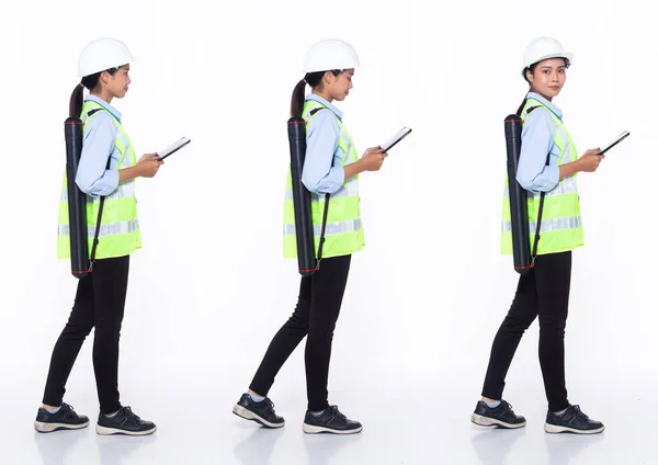 Full length 30s Asian Woman engineer architect business client, walking forward left right, wear safety gear dress. Black hair contractor female feel happy smile wellness over white background isolated