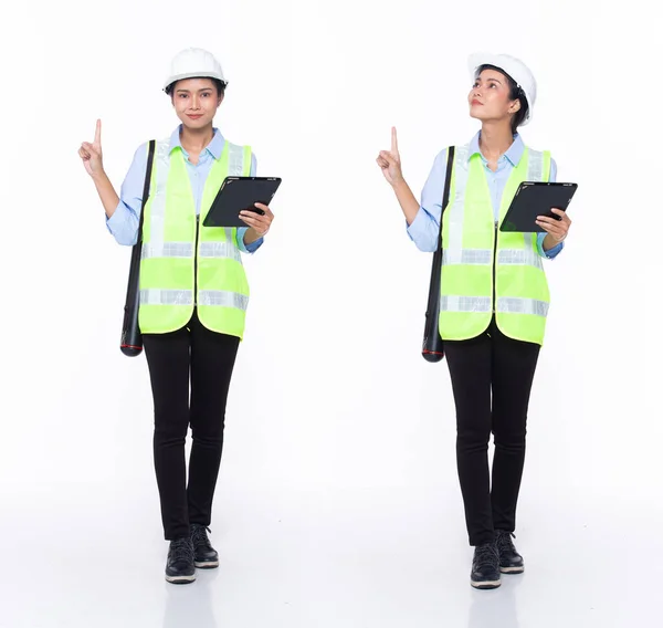 Full length 30s Asian Woman engineer architect business client, pointing finger up in Air, wear safety gear dress. Black hair contractor female feel happy smile wellness over white background isolated