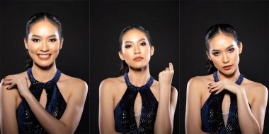 Half body of Asian beautiful woman wear blue evening sequin gown, fashion vintage poses. Young female stand express feeling happy smile strong over black background isolated