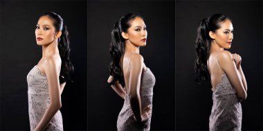 Half body of Asian beautiful woman wear white evening sequin gown, fashion vintage poses. Young female stand express feeling happy smile strong over black background isolated