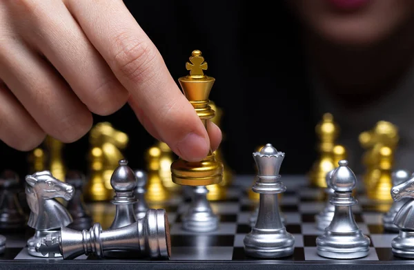 Business woman play Chess with close up Hand. Leader use strategy game to challenge competitor with intelligence leadership to move King to victory with management team idea fight, copy space