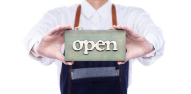 Owner person hold Open Sign Business to show service at door entrance store, cafe, retail and welcome shop. Happy Entrepreneur female wear waitress dress as open business time again concept