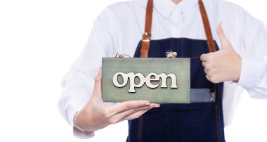 Owner person hold Open Sign Business to show service at door entrance store, cafe, retail and welcome shop. Happy Entrepreneur female wear waitress dress as open business time again concept
