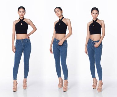 Tam boy, 20 'li yaşlarda Asyalı bir kadın resmi olarak kısa pantolon, yüksek topuklu ayakkabı giyer. Siyah uzun düz saçlı kadın mutlu bir gülümseme hissediyor. Moda modası modası beyaz arka planda izole edilmiş pozlar veriyor.