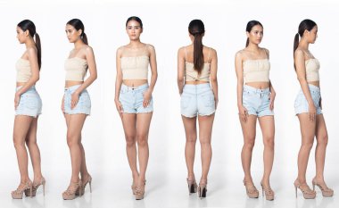 Tam boy, 20 'li yaşlarda Asyalı bir kadın resmi olarak kısa pantolon, yüksek topuklu ayakkabı giyer. Siyah uzun düz saçlı kadın mutlu bir gülümseme hissediyor. Moda modası modası beyaz arka planda izole edilmiş pozlar veriyor.