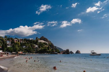 CRIMEA, GURZUF - September 02.2021: Beach with tourists on the coast.