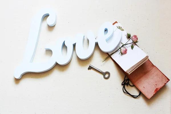 White wooden word love on vintage light background — Stock Photo, Image