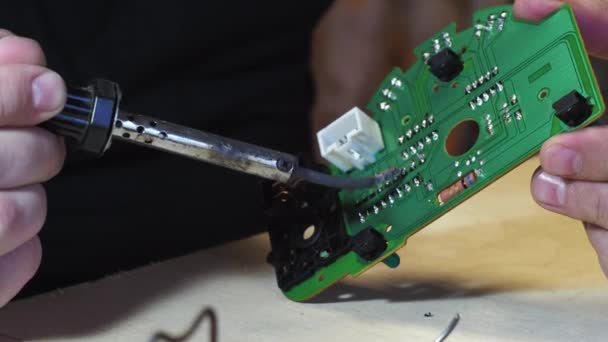 Soldering of the control unit board with a soldering iron. green board close-up — Stock Video
