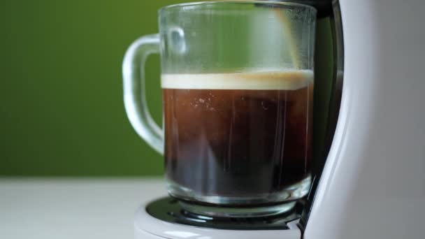 Kaffee wird aus der Kaffeemaschine gegossen. hausgemachte Küche mit heißem Americano. Einschenken von frisch gemahlenem Kaffee. morgens trinke ich gerösteten frischen Kaffee — Stockvideo