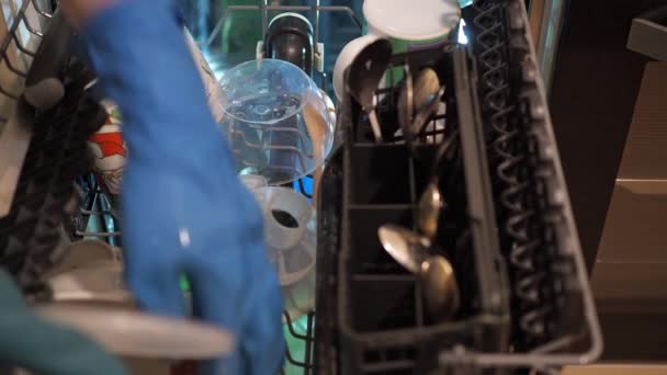 Womens hands lay out dirty dishes in the dishwasher. housework — Vídeo de Stock