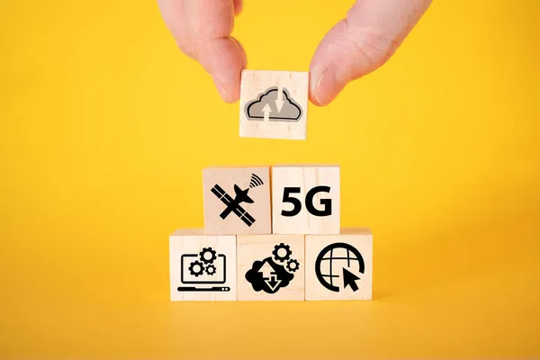 Data transfer icons on wooden cubes, yellow background. The concept of data transmission on wooden cubes.