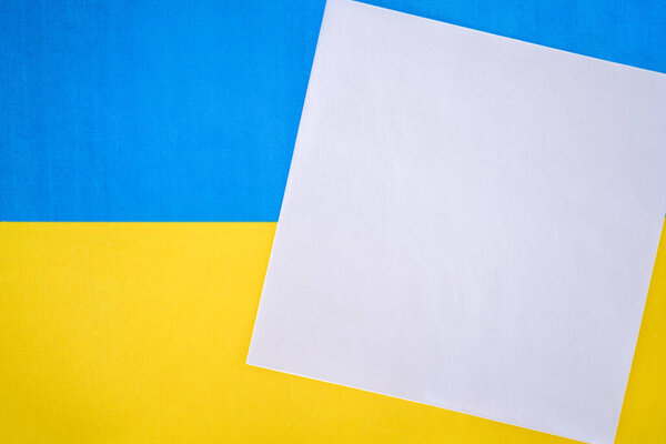 The flag of Ukraine and the white sheet. The concept of peace in Ukraine.