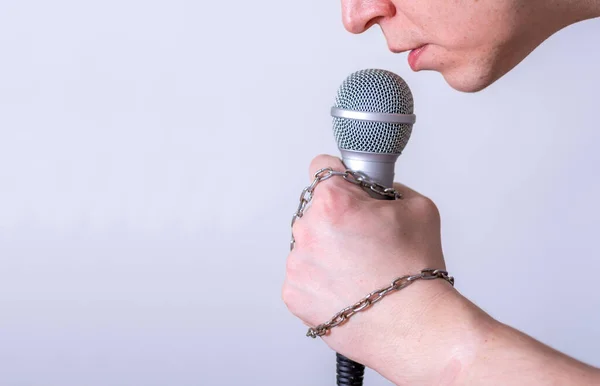 A man speaks into a microphone in close-up. World Press Freedom Day.