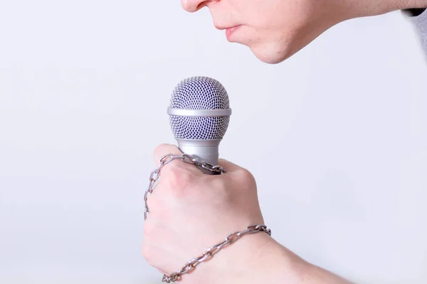 A man speaks into a microphone in close-up. World Press Freedom Day.