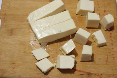 Paneer Slices isolate on wood background