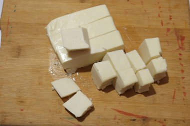 Paneer Slices isolate on wood background