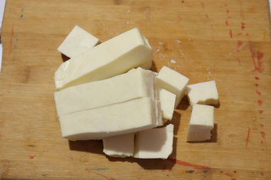 Paneer Slices isolate on wood background