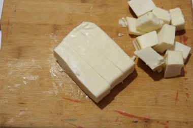 Paneer Slices isolate on wood background