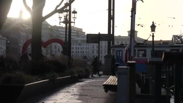 People and Tram Passing by Brunnsparken in Gothenburg City Center at Sunset — Vídeos de Stock