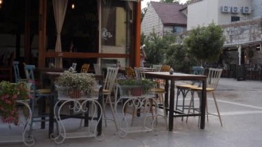 Empty Outdoor Seating in a Corner Cafe at Evening, Pan. High quality 4k footage