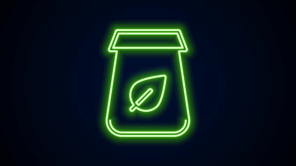 Glowing neon line Tea packaging icon isolated on black background. Paper bag with tea. 4K Video motion graphic animation — стоковое видео