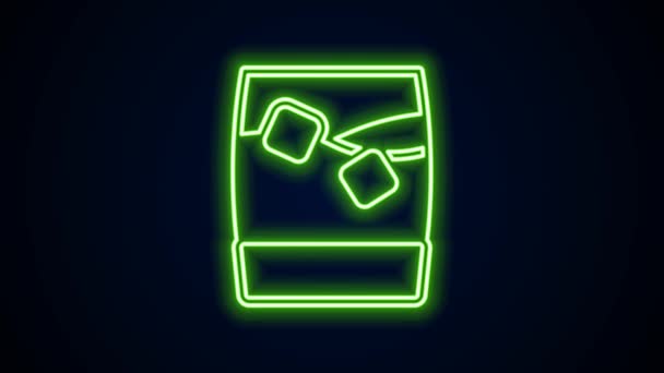 Glowing neon line Glass of whiskey with ice cubes icon isolated on black background. 4K Video motion graphic animation — Wideo stockowe